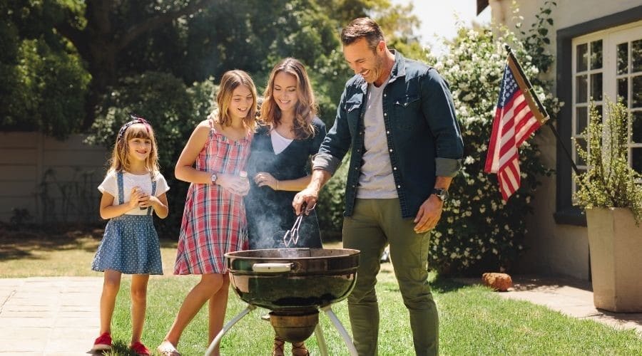 Family barbequing on a sunny day.