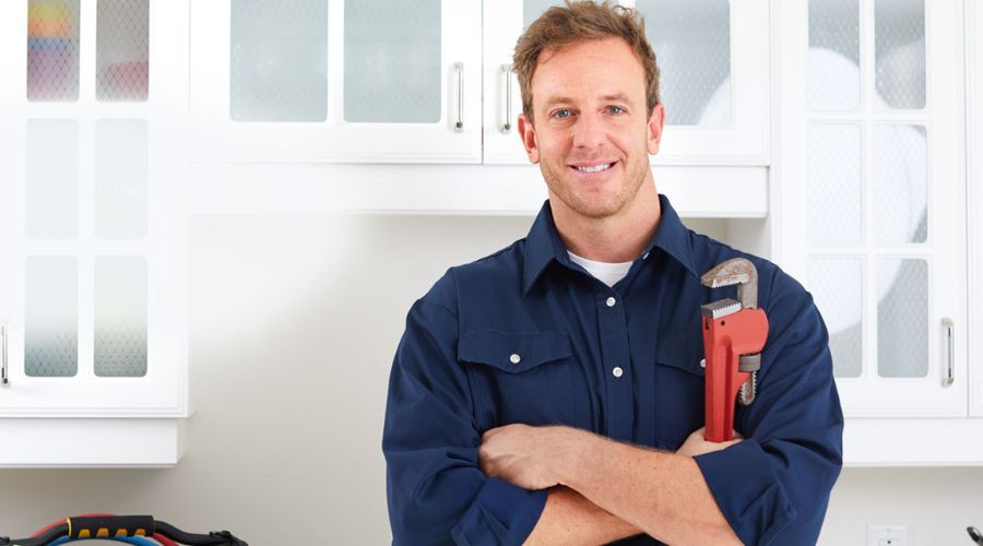 Professional plumber holding a wrench