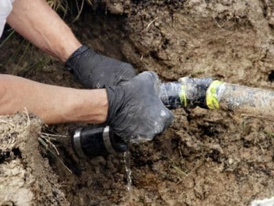 Plumber repairing an underground pipe