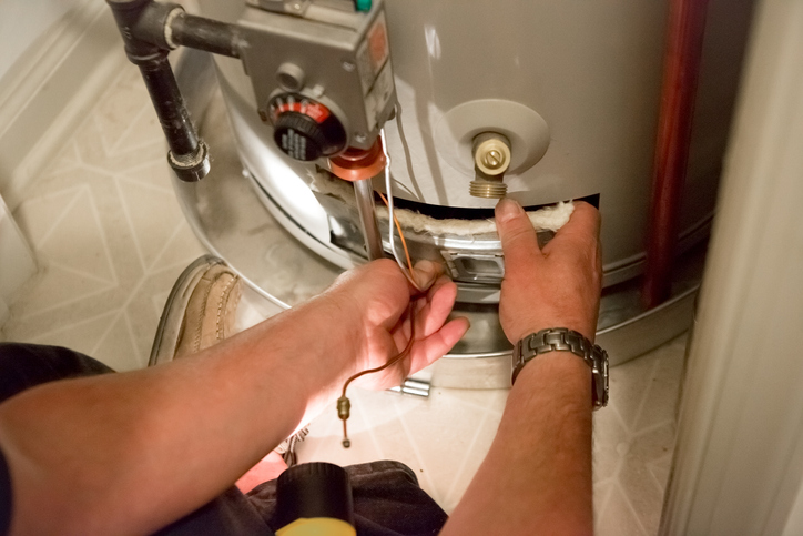 Plumber working on a water heater